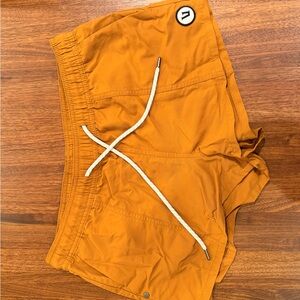 Vuori Athletic Shorts in Orange